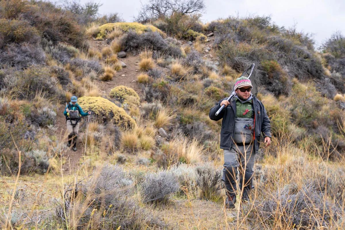 Guillermo Cifunetes and Christine Marozick navigate the challenging terrain on the way to the river.