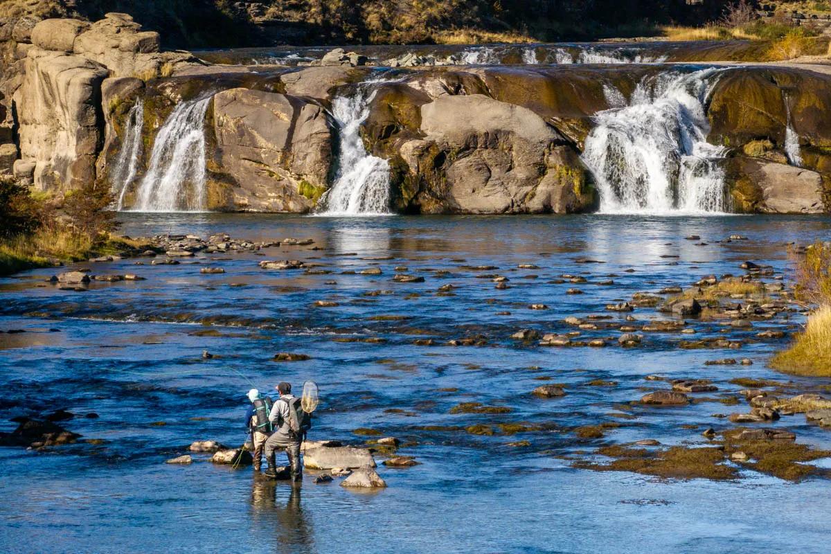 Christine Marozick and guide Ives Barrientos cast to risers beneath the cascades on Río Huemules.