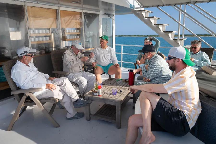 Gathering on the upper deck after fishing each day to enjoy a cold beer and Cuban cigars.