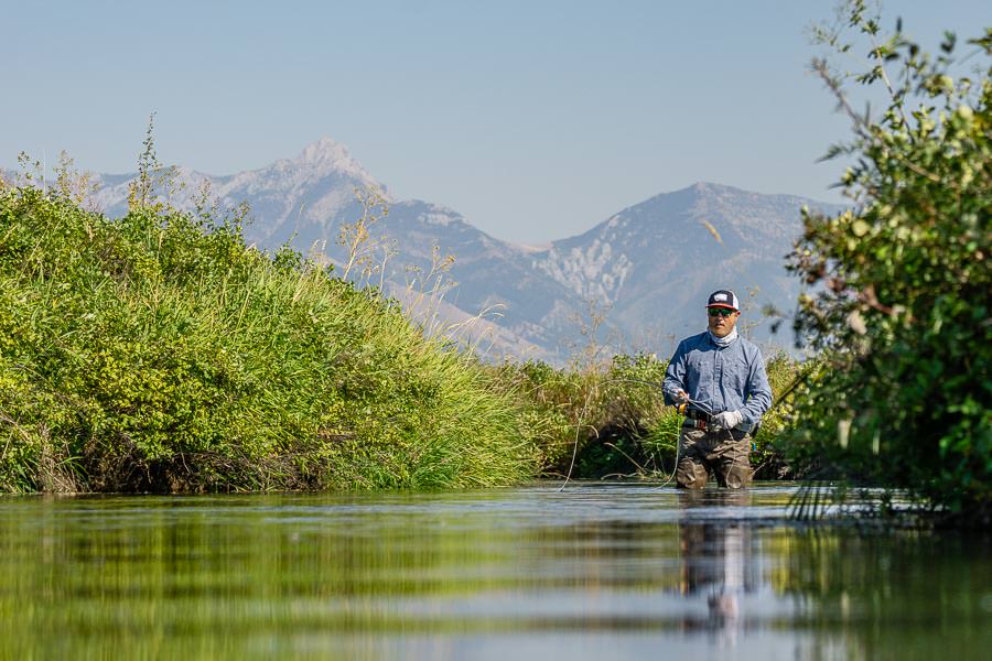 Fishing On A Small Mountain River In The Frame Of A Fisherman's